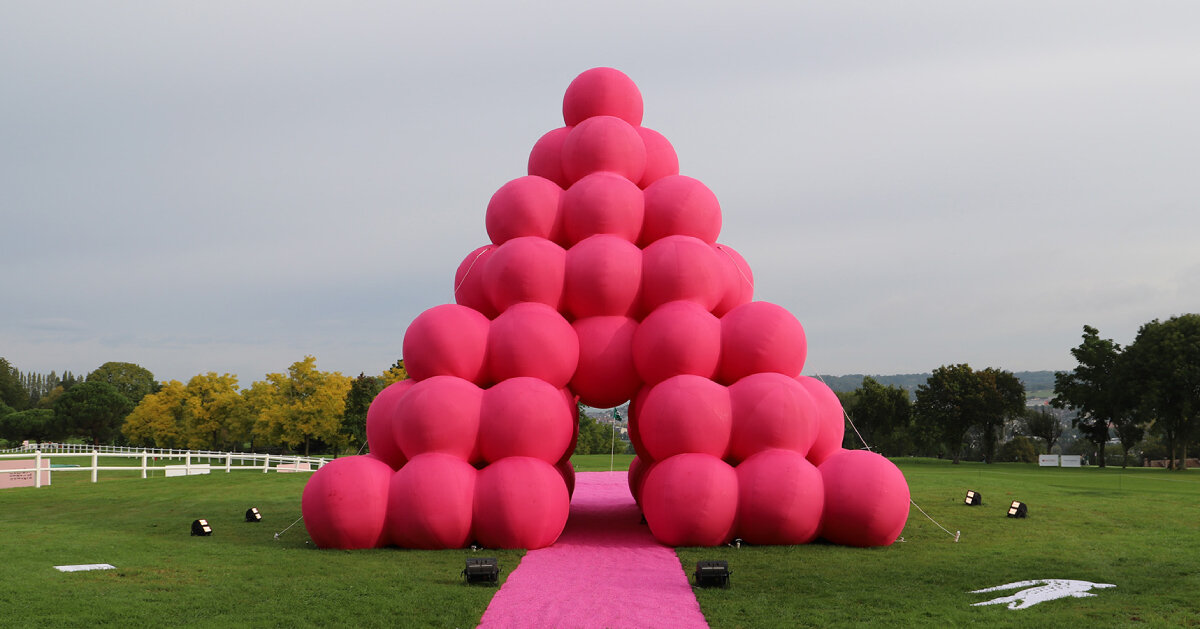 cyril lancelin stacks inflatable pink spheres into monumental pyramid in france