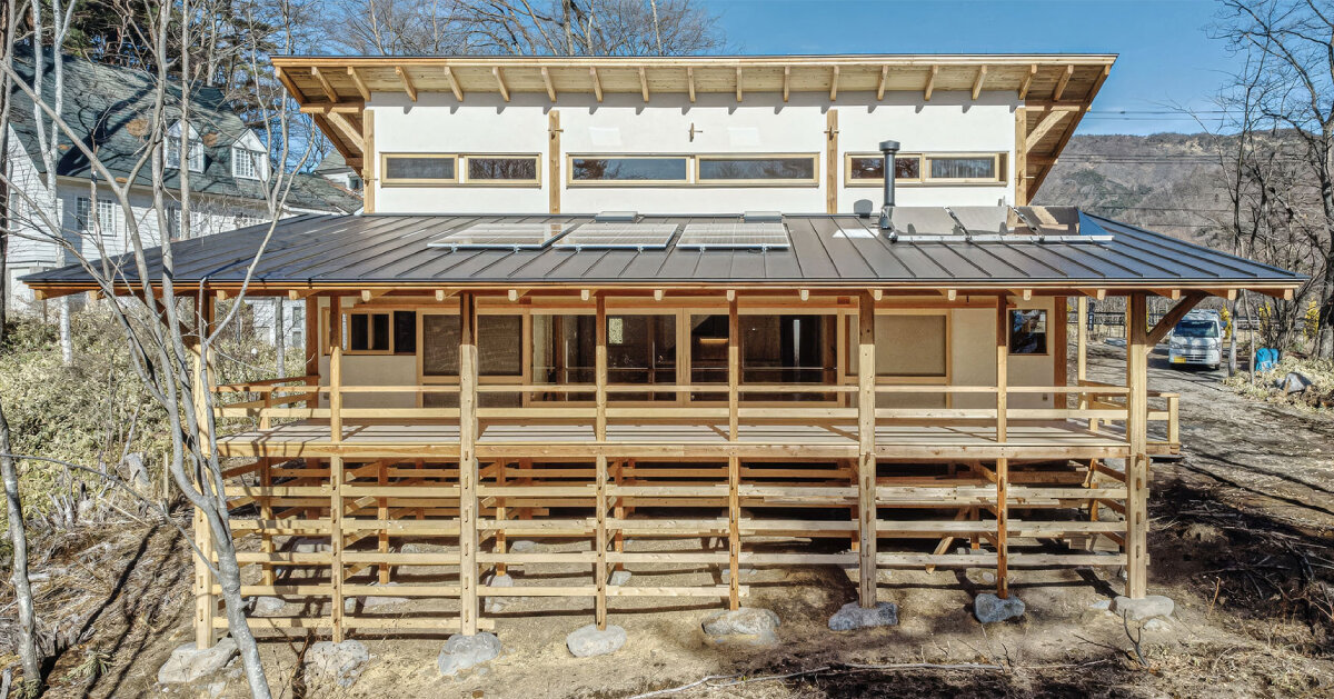 sobokuya rests wooden home on stone foundation near mount yatsugatake in japan