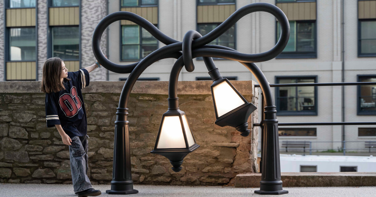 alex chinneck knots street lamps and twists a phone booth for his assembly bristol sculptures