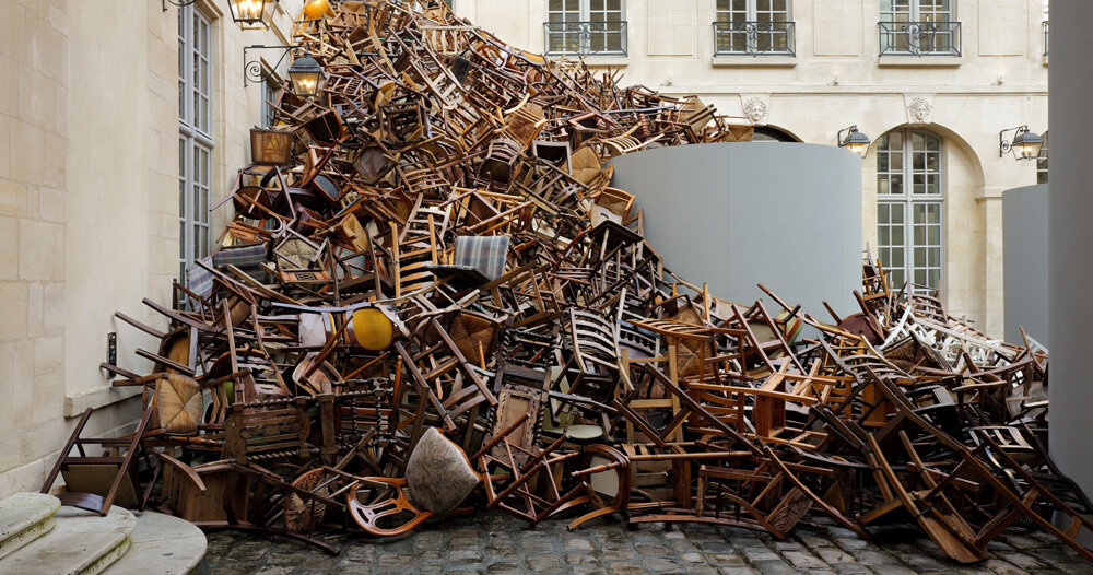 tadashi kawamata’s tumbling avalanche of wooden chairs sweeps through paris courtyard