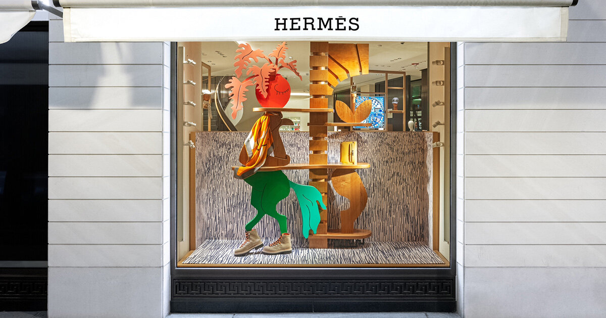 Hermès faubourg marks 100 years with surreal figures animating its windows displays