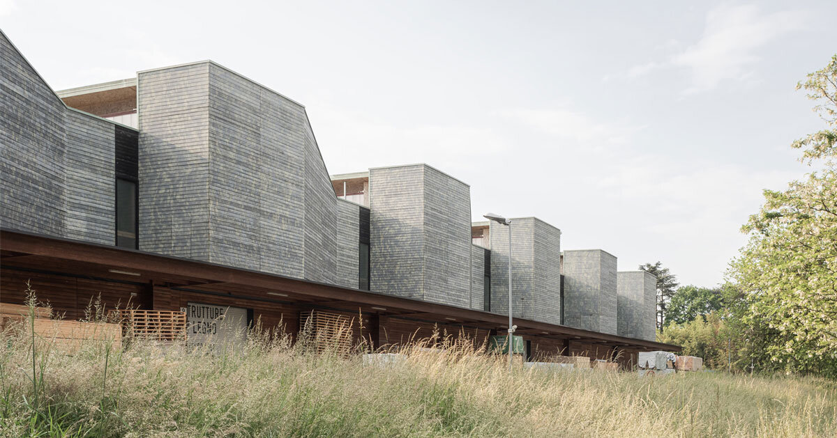 seven wood&clad boxes set in rhythmic sequence outline industrial building’s facade in italy