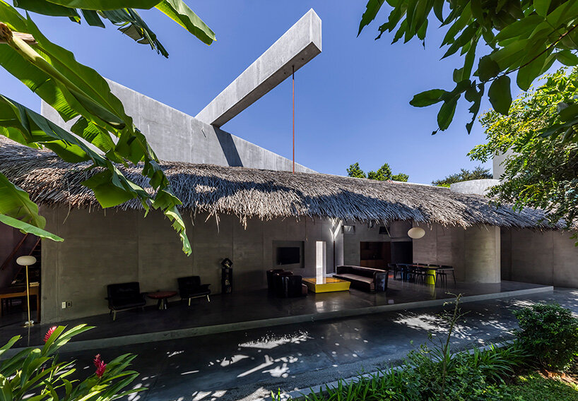 timber waffle roof shields constellation of living spaces in vietnamese residence by kientruc o