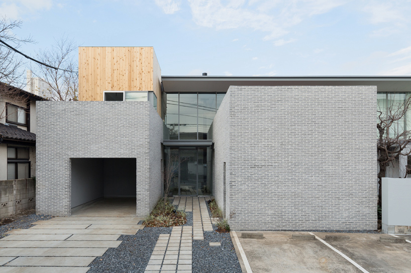 comma design office arranges tokyo dwelling around grey-brick wall