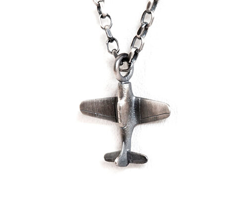 long silver airplane pendant necklace, a playful reminder of exciting days to come