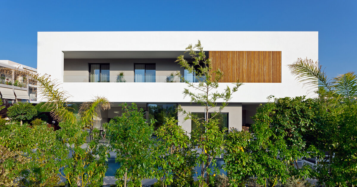 circular roof aperture sheds light through 'frame house' in greece