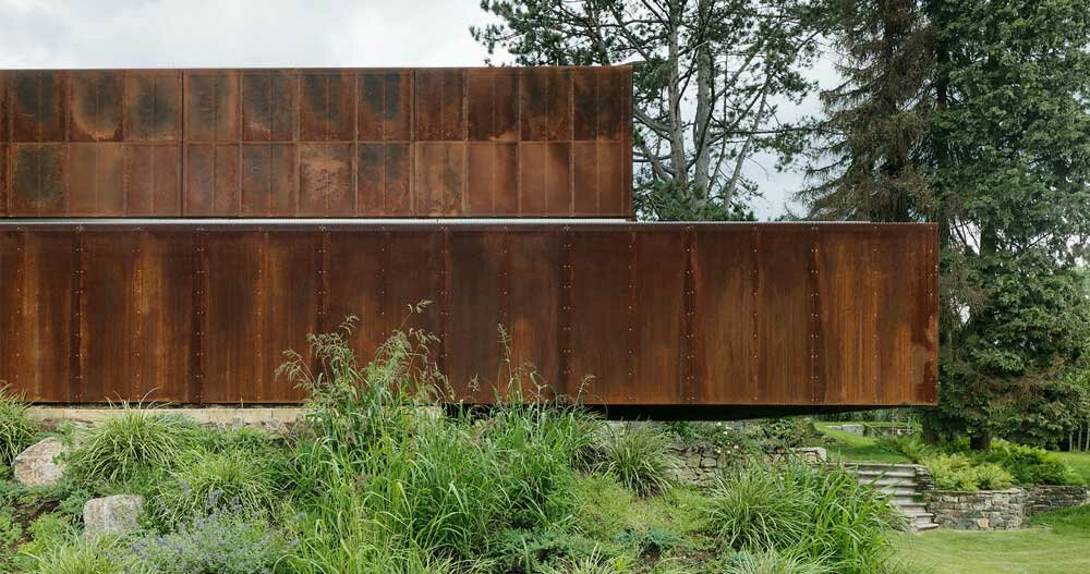 trio of rusted steel volumes forms 'deconstructed house' in austria