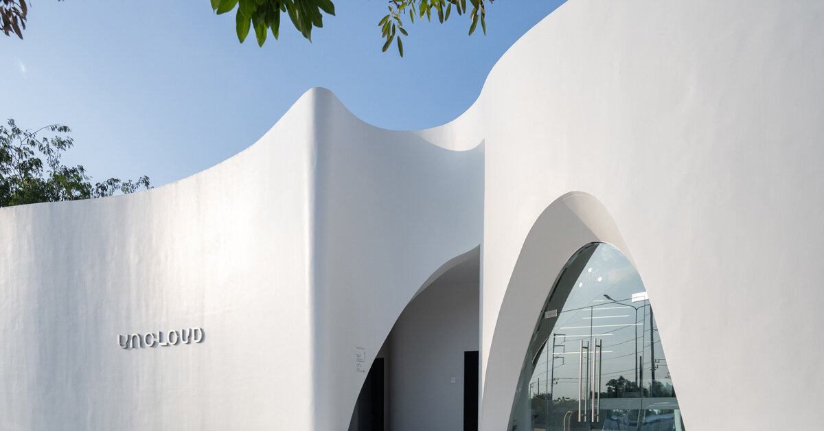 uncloud coffee's arching white structure integrates smoothly into its ...