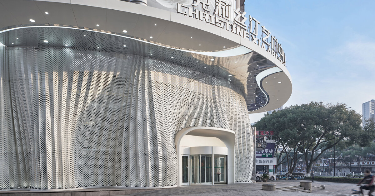 antistatics architecture echoes rippling fabric in perforated metal at wedding center in china