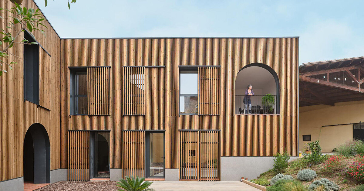 wooden sliding shutters frame arched openings in spanish renovation by sergi pons studio