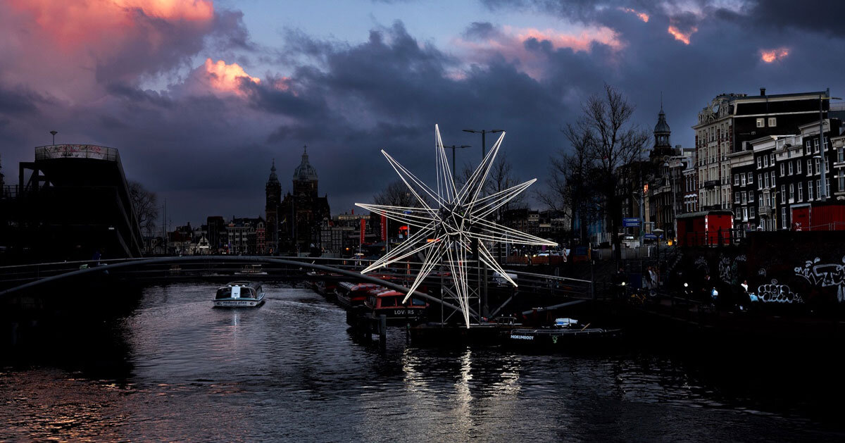 polaris glowing star installation lights up in the heart of amsterdam