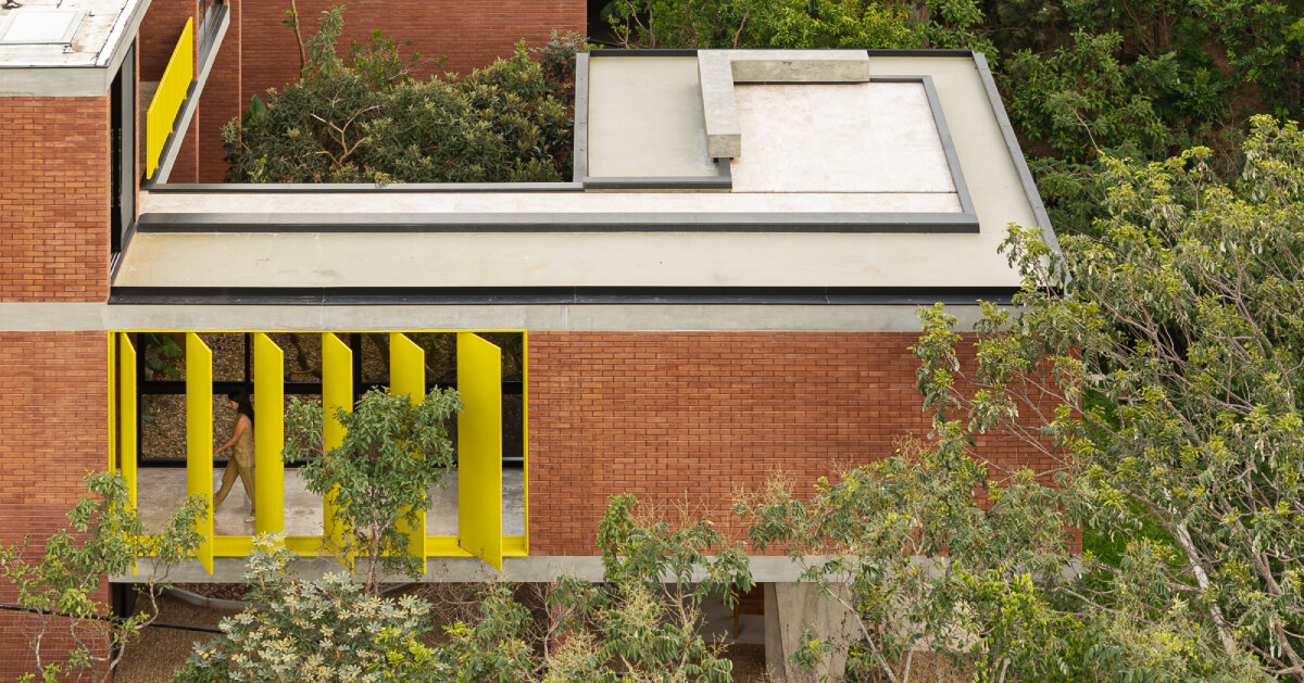 bold yellow louvers bring brazilian forest into house of 7 trees by hersen mendes arquitectura