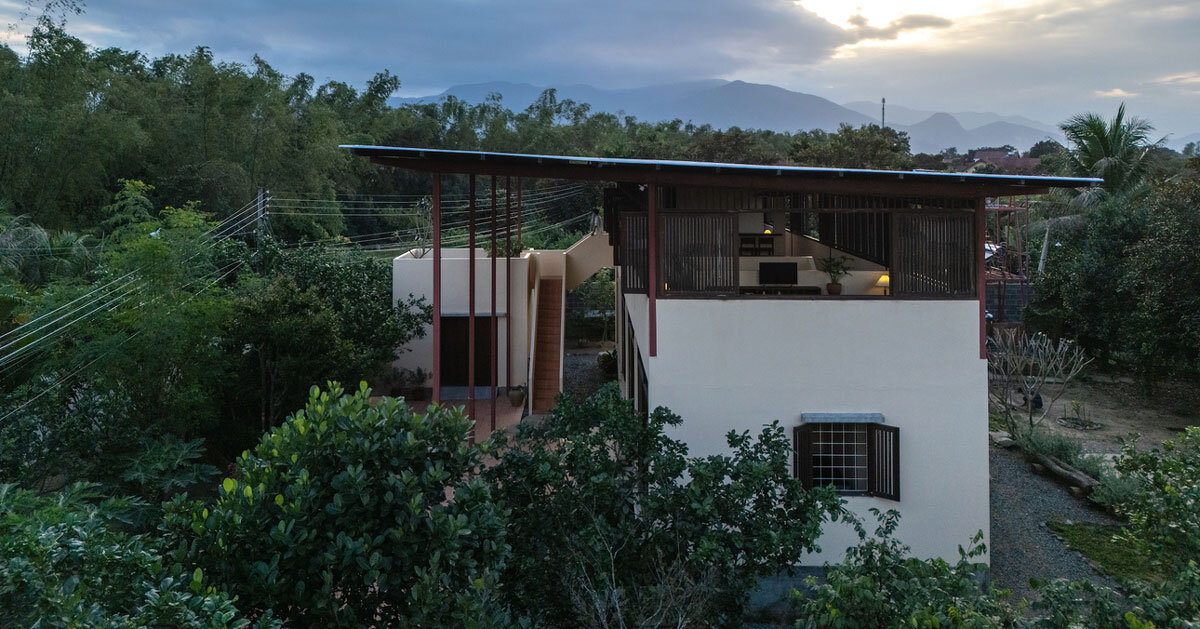 sloping metal roof shields garden house’s open living space by SAL in vietnam