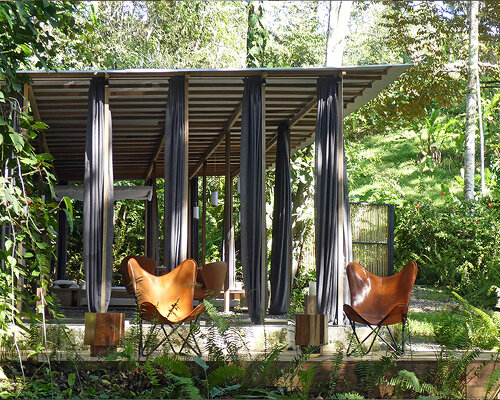 slender wooden columns shape this wall-less open jungle house in the costa rican rainforest