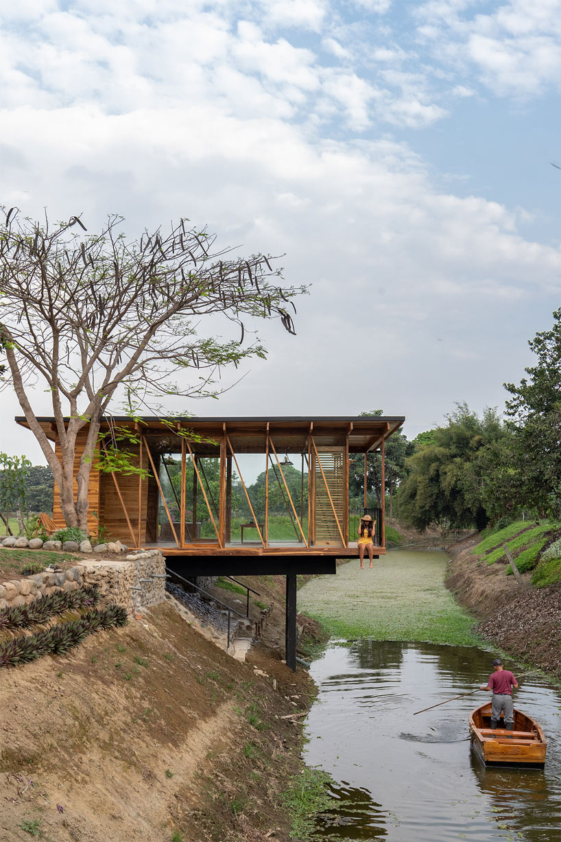 natura futura raises a timber tea room over a water channel in ecuador