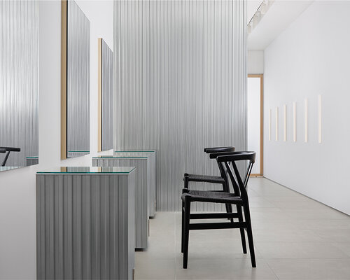 aluminum and polycarbonate plates add an industrial touch to minimal japanese hair salon