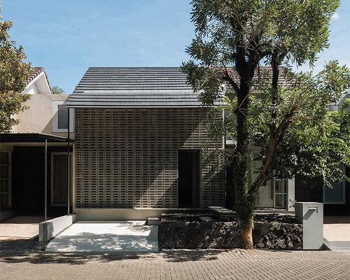 interlocking spaces behind perforated brick facade turn home into office in indonesia