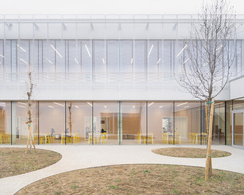 artico fracassi wraps italian school in glass and perforated encasing to bring the outdoors in