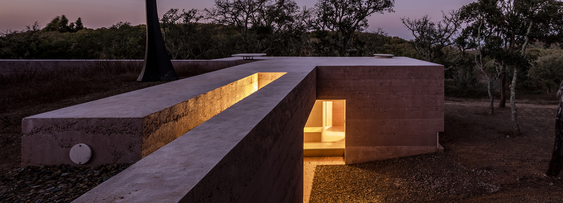 the minimalist cottage house is embedded into the landscape of southern portugal