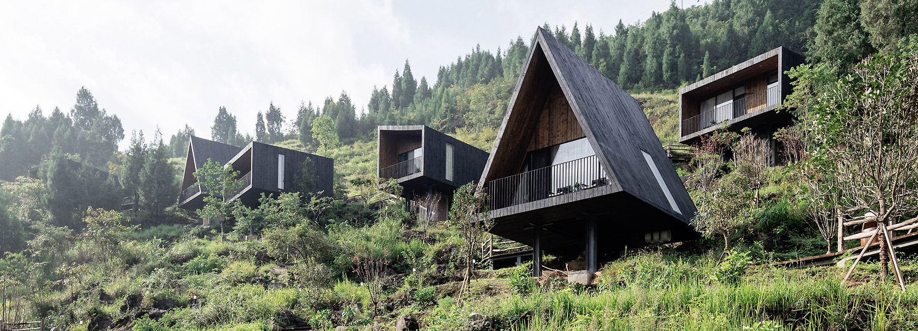 ZJJZ builds charred timber volumes in rural china for 'woodhouse hotel'