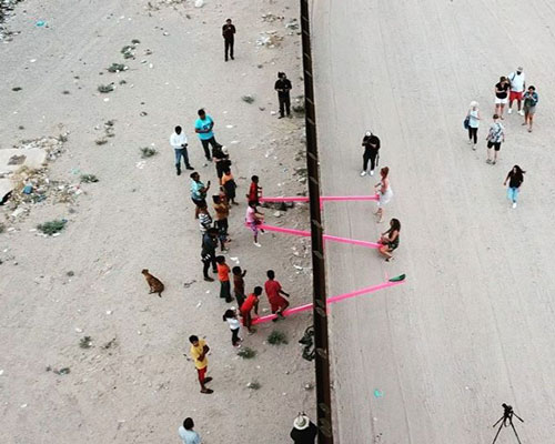rael san fratello installs pink seesaws on US-mexico border wall