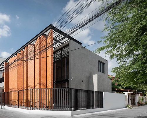overlapping strips of terracotta tiles shade archimontage's pakkret house in thailand