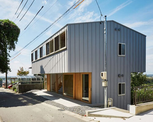masaki ihara integrates house with tiered foundation into small japanese mountain