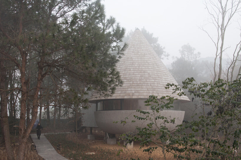 The Mushroom by ZJJZ is a cone-shaped guest house in the woods of Jiangxi,  China