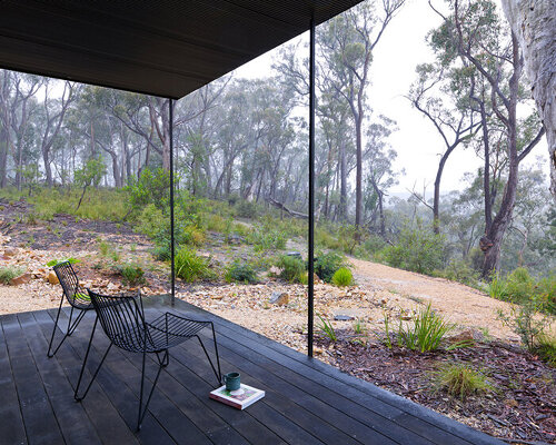 timber clad off-grid house is perched on the ridge of blue mountains bushland, australia