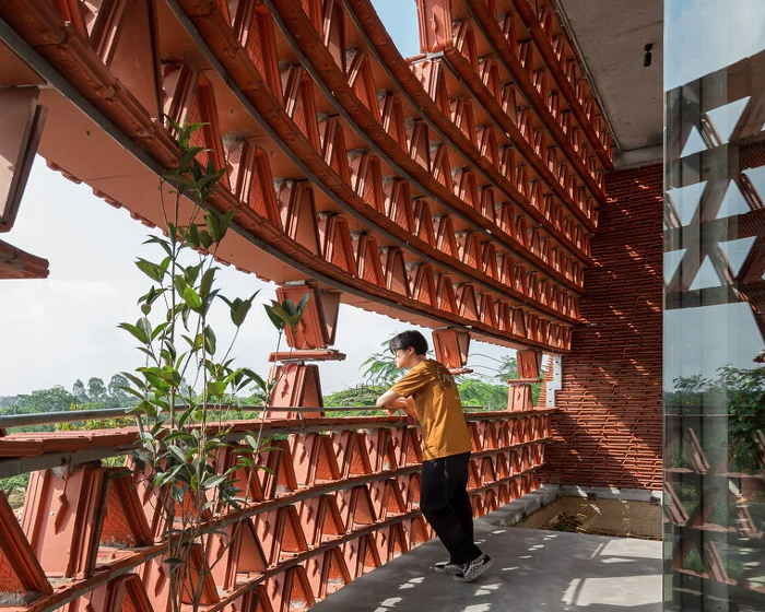 20,000 tiles wrap around H&P architects' multipurpose building in hanoi, vietnam