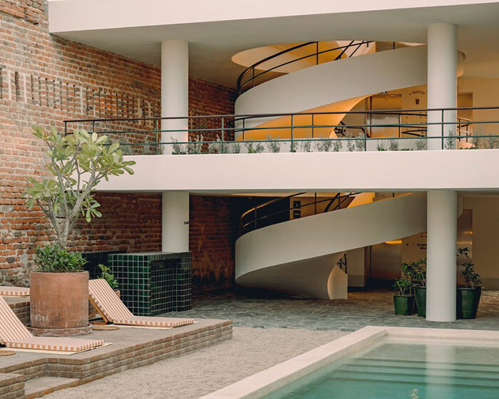 sculptural helical staircase adorns this 1910 colonial-style villa turned hotel in mexico