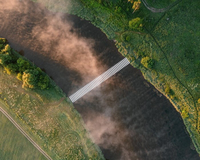 a symbolic crosswalk traverses moscow river in land art by gregory orekhov