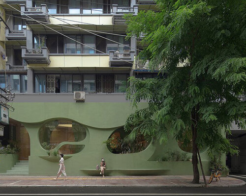 irregular curves bring nature inside this pastel green café in china