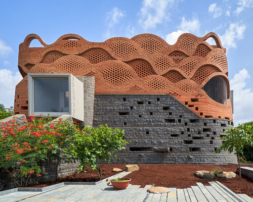 curved red bricks crown a family home in india designed by PMA madhushala