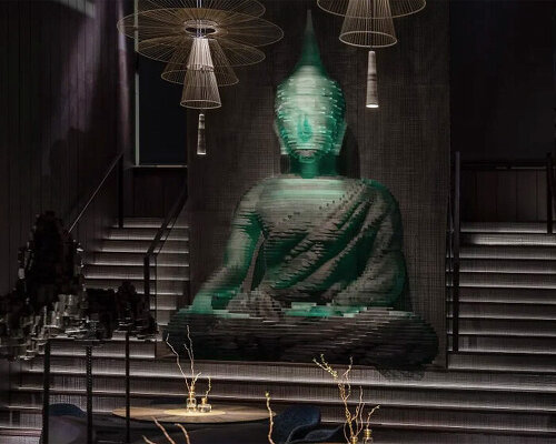 4.5-meter-tall glass-hewn buddha sculpture decorates restaurant interior in new york