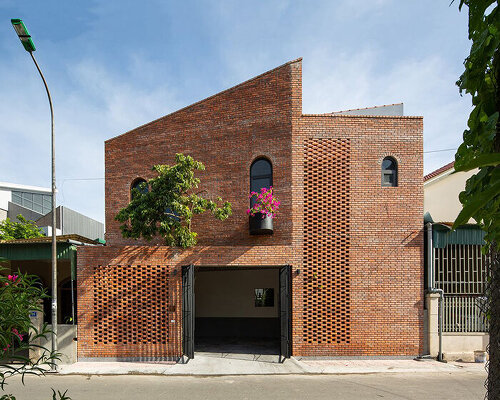 dom architect studio incorporates nature into brick-clad house in bustling vietnamese center