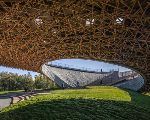 curved wooden lattice forms yangliping performing arts center cantilevered over mountain in china