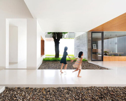 inward-facing family house in indonesia is arranged around a semi-open patio