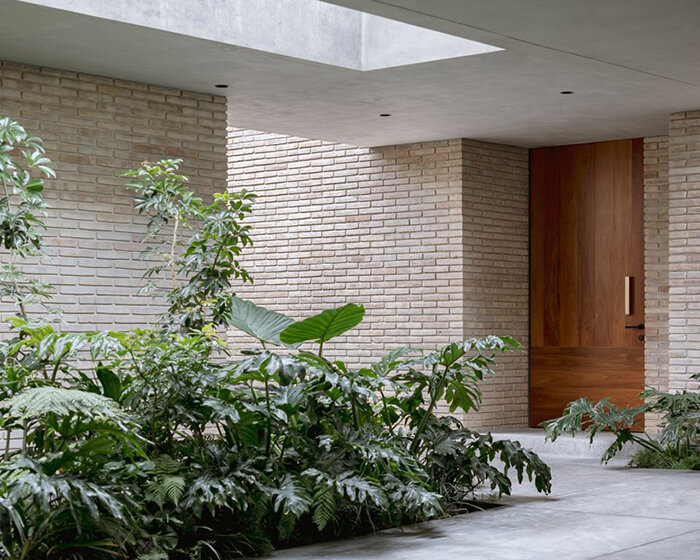 white clay brick residence revolves around interior courtyards in mexico city