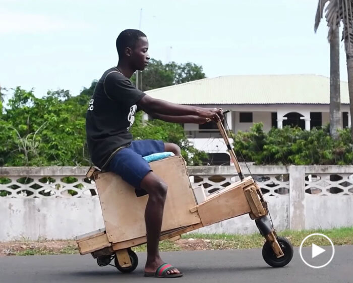 teenager in ghana handcrafts wooden, electric, and solar-powered motorbike