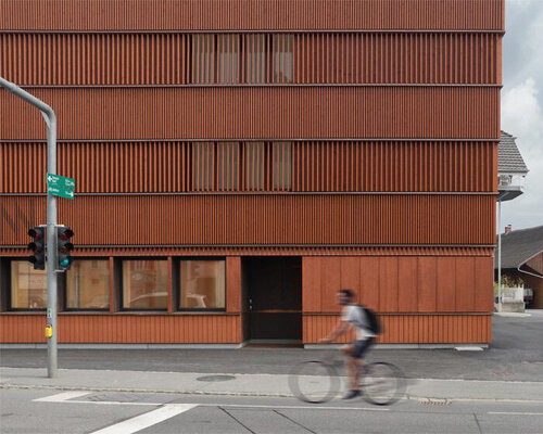 rusty red wooden guesthouse by ludescher + lutz revitalizes rhine valley town in germany