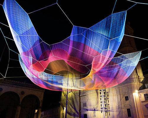 studio echelman weaves flowing and luminous 'earthtime' for mercedes benz in munich