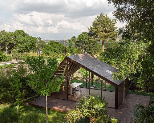 complex curvy bookshelves decorate this writer’s cabin immersed in the nature of madrid