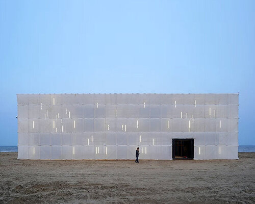 scaffolding wrapped in translucent cloth assembles temporary pavilion on chinese beach