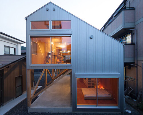 midorichio house in japan emerges from wooden skeleton forming a piloti