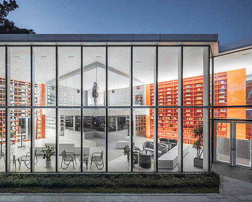 bright red bookshelves shine through glass box bookstore by wutopia lab in china