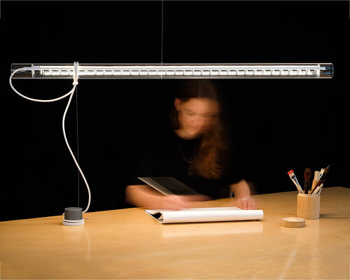 ingo maurer's 'tubular balance' is a hybrid between a pendant light and a table lamp