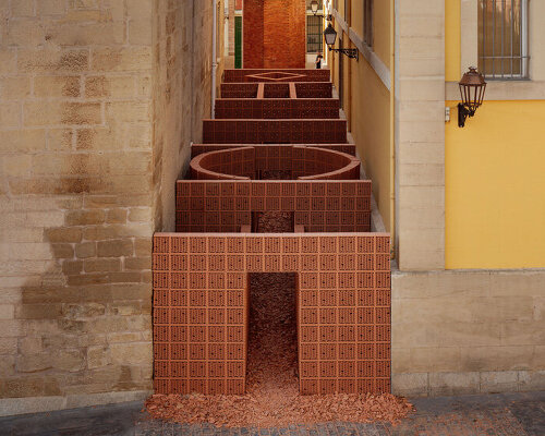 PALMA + hanghar insert temporary brick pavilion in an old factory's narrow passage in spain