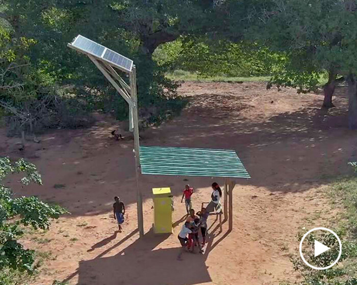 'solar giraffe' is a communal space to charge cellphones in mozambique