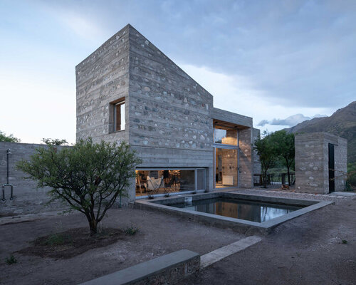 nanzer | vitas echoes a ruinous fortress in argentina with its stone-clad casa DP